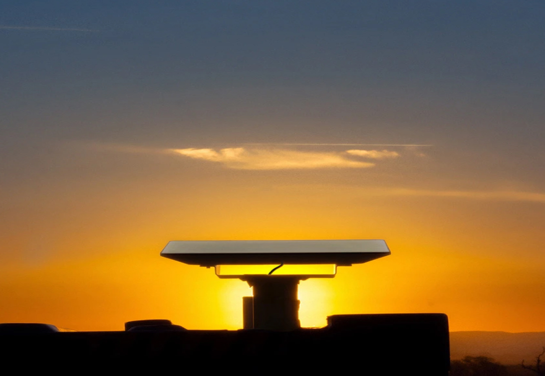 Photo of a Starlink satellite with a sunset behind it