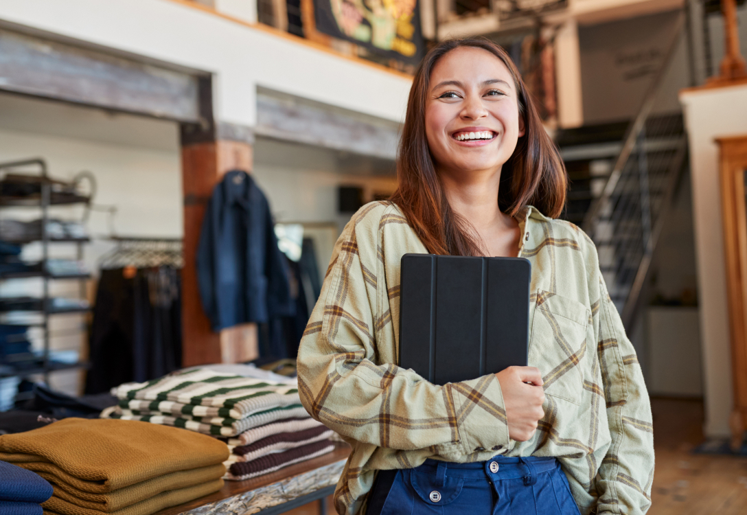 Portrait Of Female Owner Of Fashion Store Using Digital Tablet